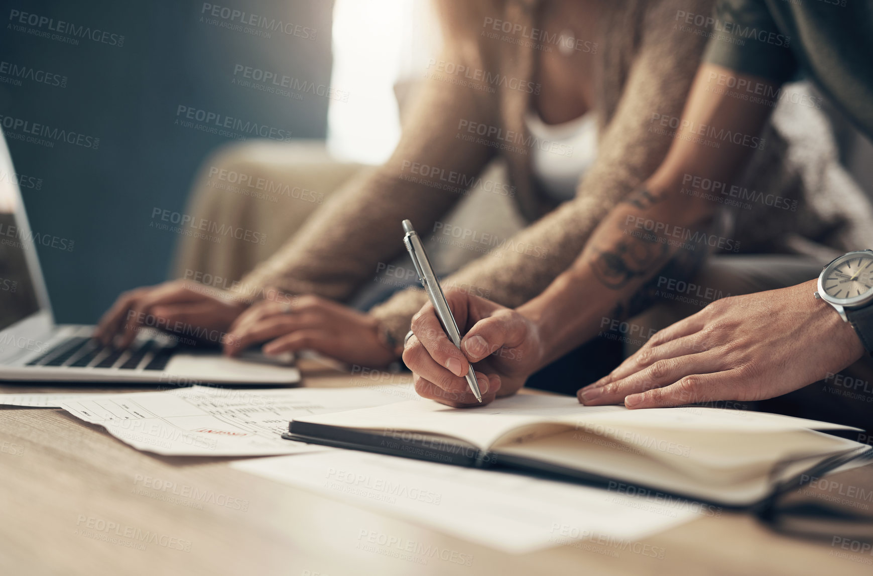 Buy stock photo Cropped shot of a couple going over paperwork at home
