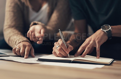 Buy stock photo Cropped shot of a couple going over paperwork at home
