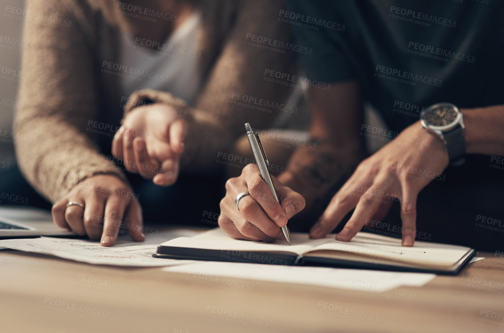 Buy stock photo Cropped shot of a couple going over paperwork at home