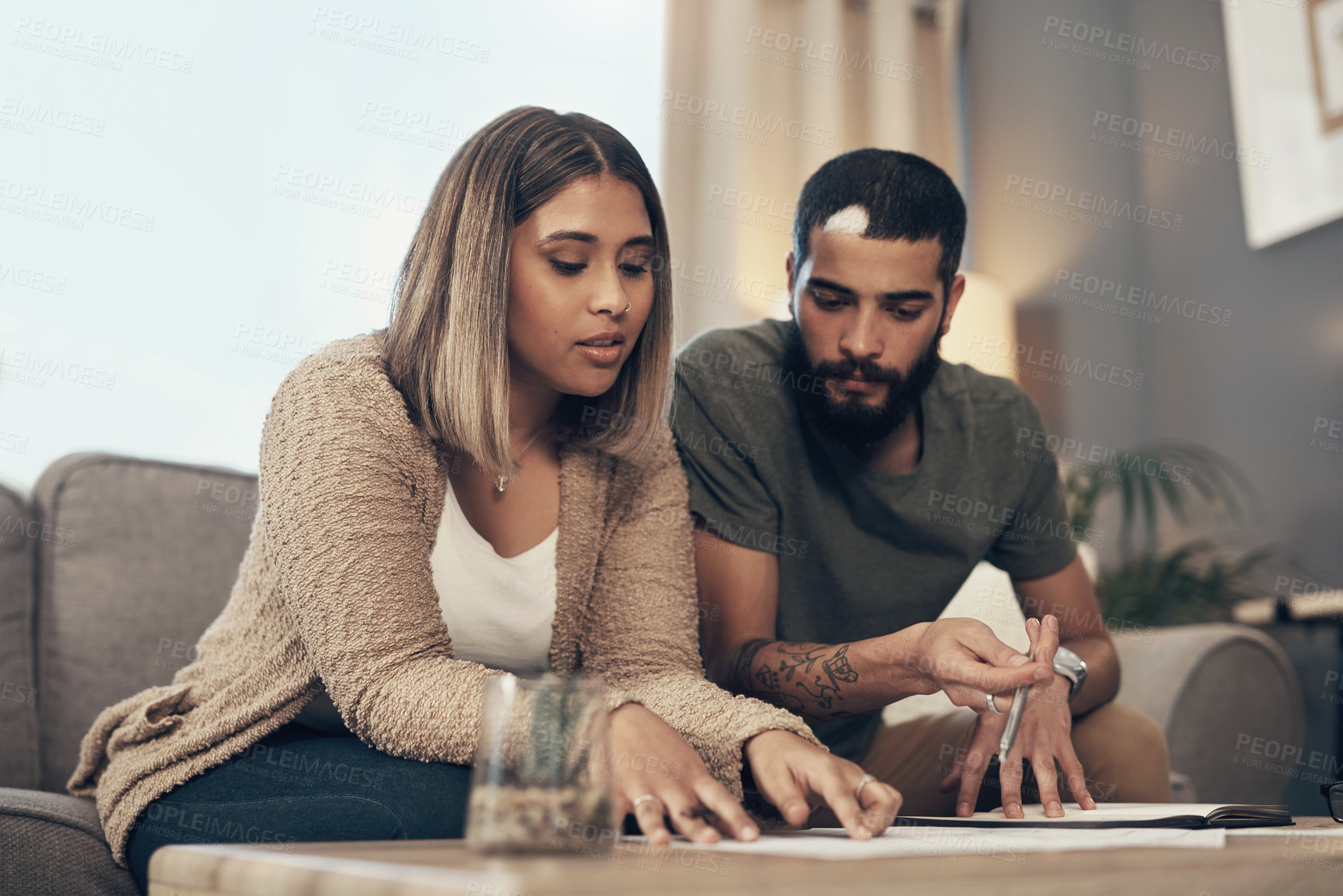 Buy stock photo Home, couple and reading with legal documents for mortgage or loan agreement on sofa. Apartment, people and serious together in living room with paperwork, form and contract for life insurance