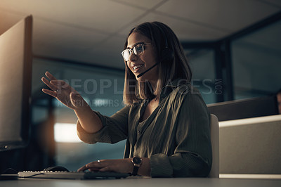 Buy stock photo Shot of a call centre agent working in an office at night