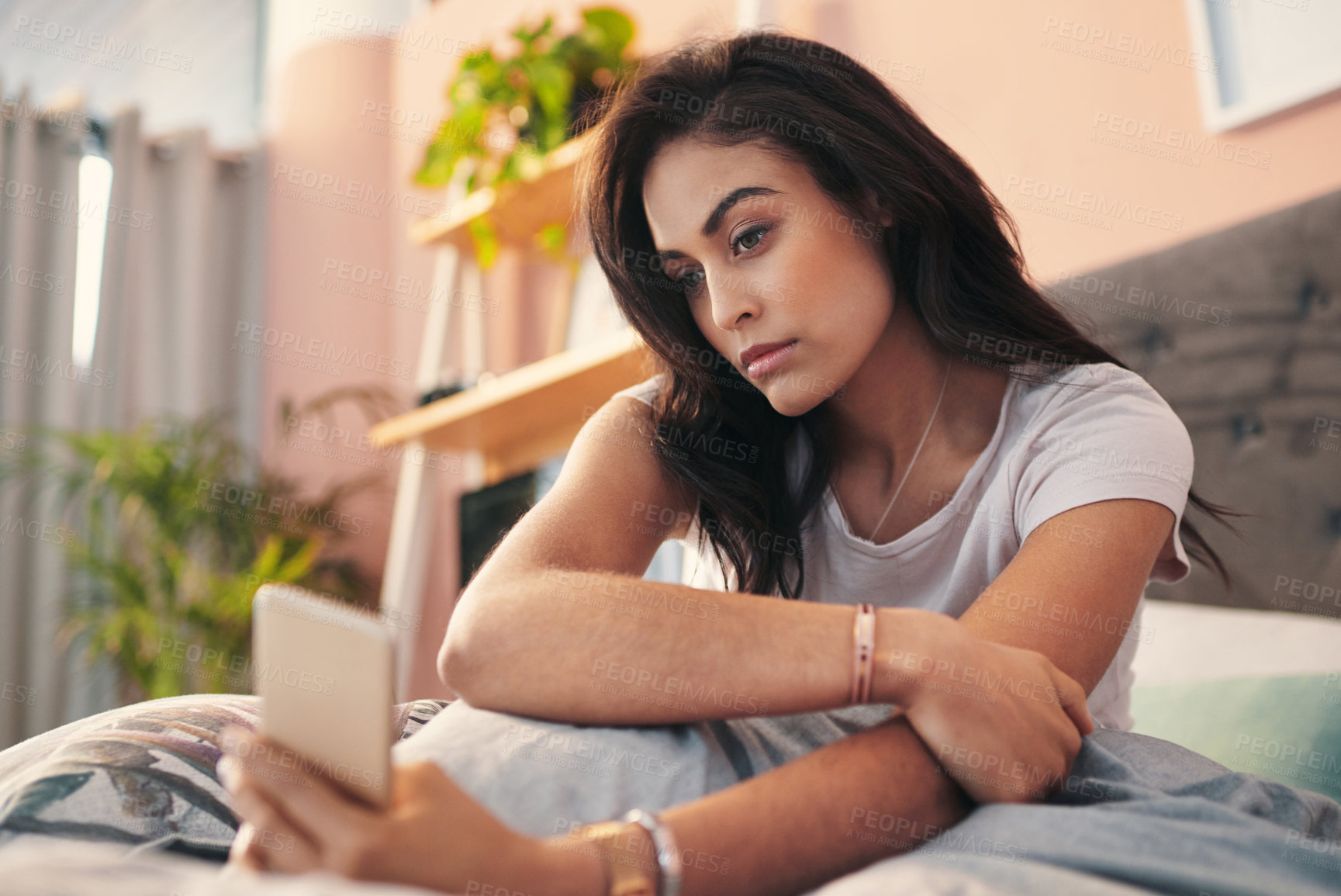 Buy stock photo Shot of a young woman taking selfies in bed at home