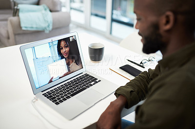 Buy stock photo Shot of a young man using a laptop to have an online lesson via video conference