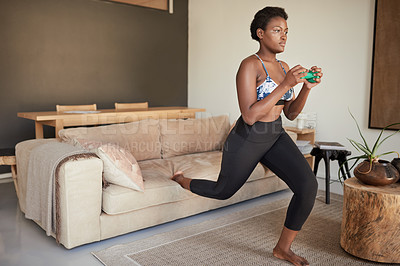 Buy stock photo Shot of a young woman exercising at home