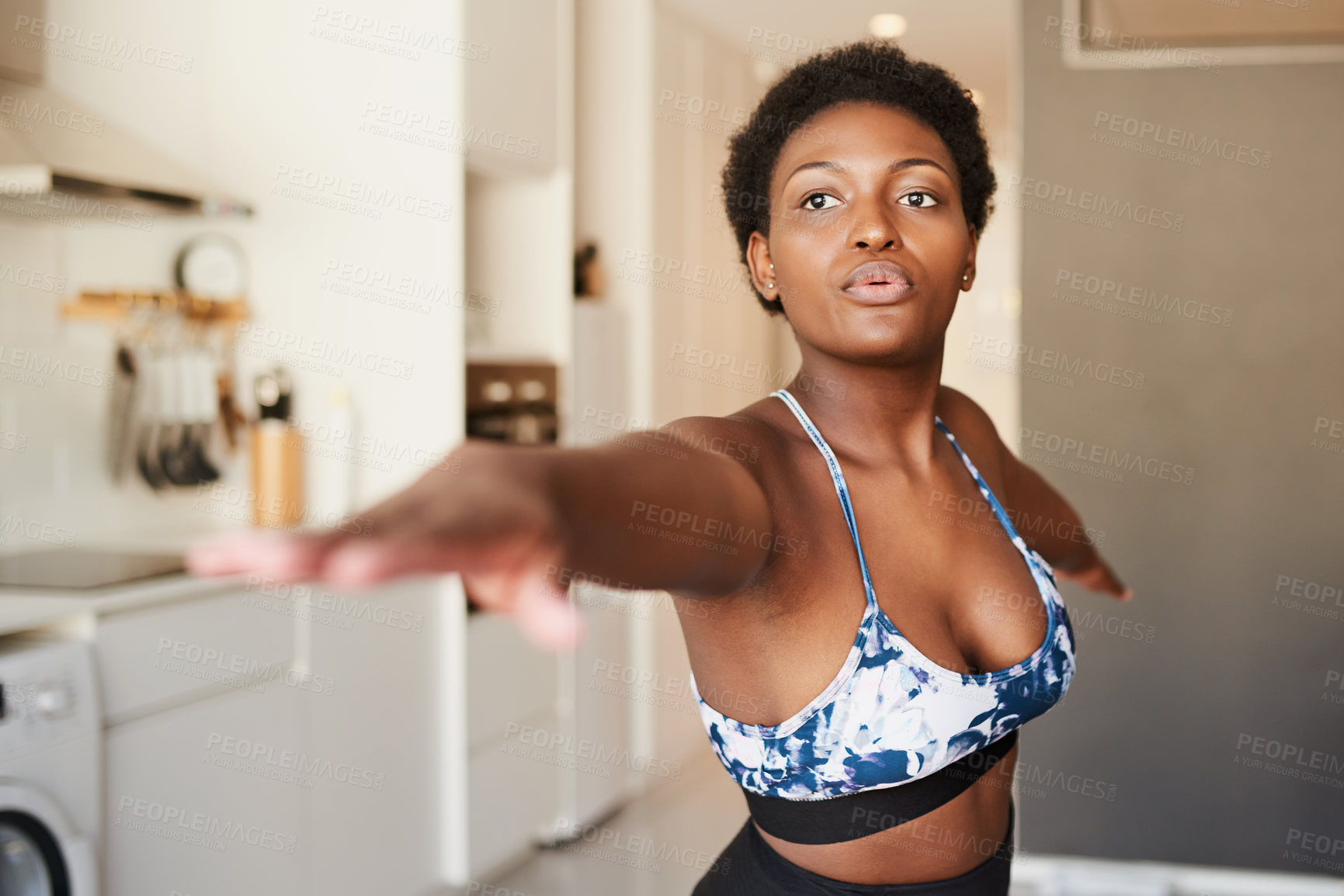 Buy stock photo Shot of a young woman exercising at home