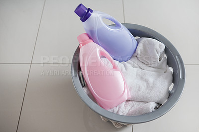 Buy stock photo High angle shot of a washing basket filled with clean laundry and two bottles of fabric softener
