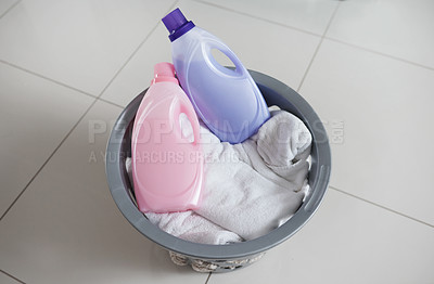 Buy stock photo High angle shot of a washing basket filled with clean laundry and two bottles of fabric softener