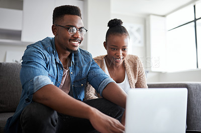 Buy stock photo Sofa, black couple and typing on laptop in home living room on social media, internet browsing or watching movie. Love, man and woman sitting on couch with computer tech reading email or web surfing.