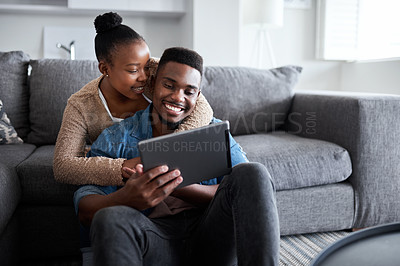 Buy stock photo Social media, movie and African couple with a tablet for communication, mobile app and internet connection. Digital, tech and black woman with hug for man while streaming on a subscription service