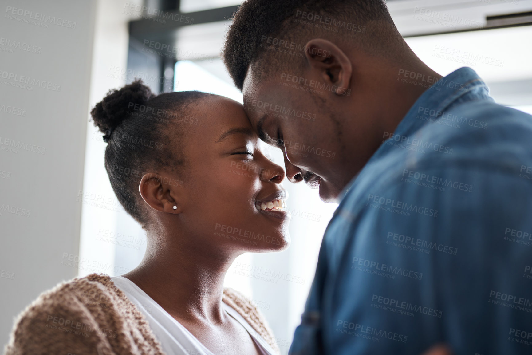 Buy stock photo Love, black couple embrace in new home and smile in support of young marriage relationship. First time homeowner, happy man and black woman standing in window of city apartment in New York together.