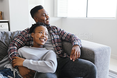 Buy stock photo Shot of a young couple relaxing on a sofa together at home