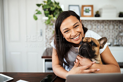 Buy stock photo Portrait of a young woman sitting with her pet dog on her lap while working from home