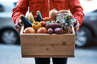 Buy stock photo Cropped shot of a man delivering a crate full of fruit and vegetables