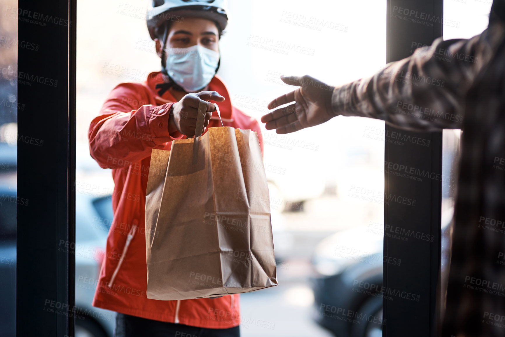 Buy stock photo Shot of a masked man delivering a food package