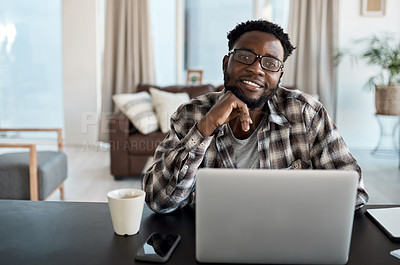 Buy stock photo Portrait of a young man working on a laptop at home