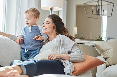 Buy stock photo Shot of a pregnant woman bonding with her toddler son at home