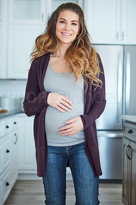 Buy stock photo Cropped portrait of an attractive young pregnant woman standing in her kitchen at home
