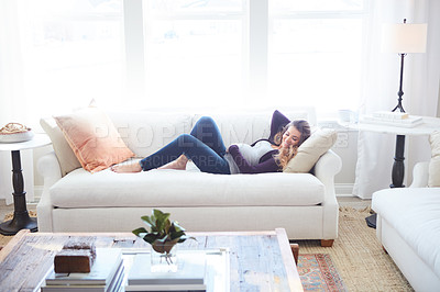 Buy stock photo Full length shot of an attractive young pregnant woman taking a nap on the sofa at home