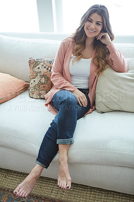 Buy stock photo Shot of a beautiful young woman relaxing on a sofa at home