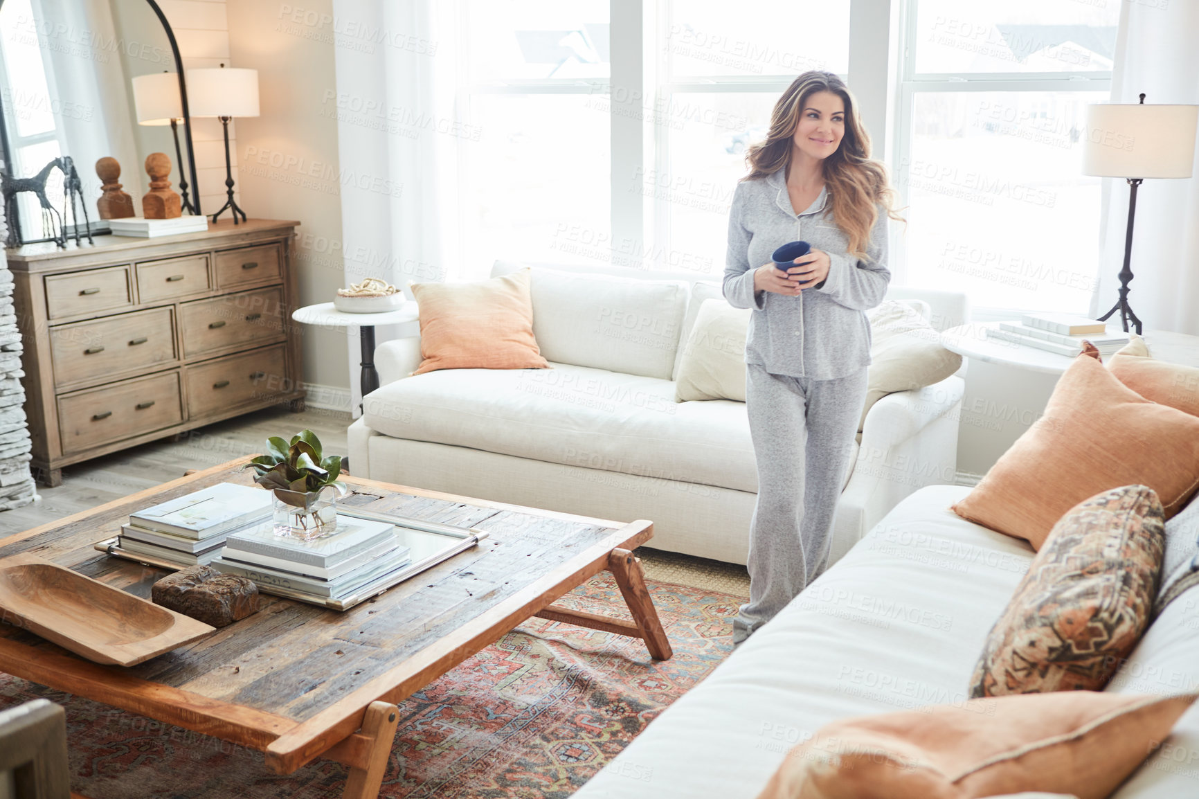 Buy stock photo Shot of a beautiful young woman having coffee during a relaxing morning at home