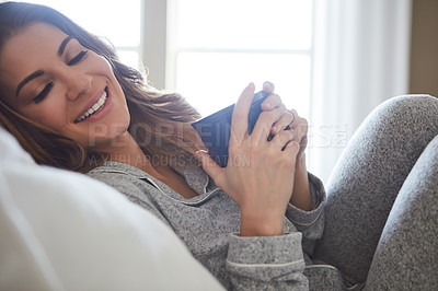 Buy stock photo Shot of a beautiful young woman having coffee during a relaxing morning at home