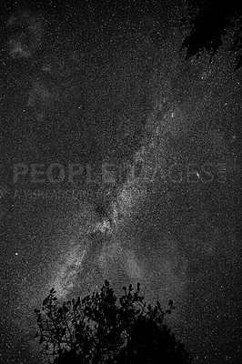 Buy stock photo Milky way galaxy. Below shot of stars against a pitch black sky on a dark night. Dark sky illuminated by a starry night. A beautiful background, screensaver of wallpaper