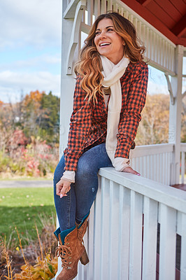 Buy stock photo Full length shot of an attractive young woman sitting on the ledge of a gazebo in the park during autumn