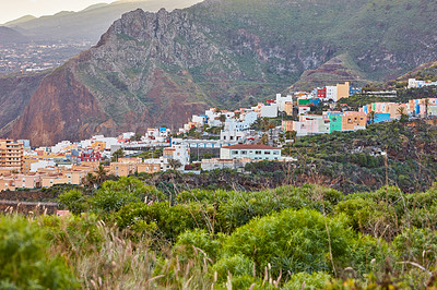 Buy stock photo Colorful buildings in Santa Cruz, La Palma, Canary Islands with copy space. Beautiful cityscape with bright colors and mountains. A vibrant holiday, vacation and getaway destination on the hillside