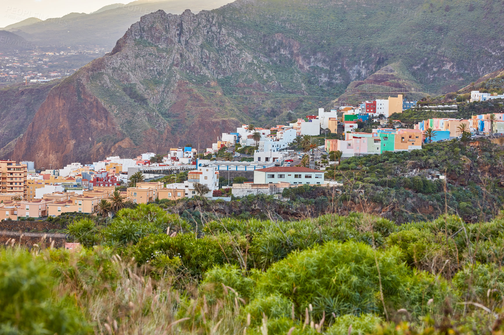 Buy stock photo Colorful buildings in Santa Cruz, La Palma, Canary Islands with copy space. Beautiful cityscape with bright colors and mountains. A vibrant holiday, vacation and getaway destination on the hillside