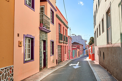 Buy stock photo Historical city street view of residential houses in small and narrow alley or road in tropical Santa Cruz, La Palma. Village view of vibrant buildings in popular tourism destinations overseas