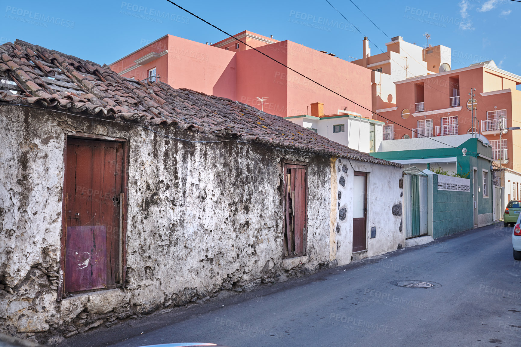 Buy stock photo Exterior of decaying brick buildings with peeling paint in a street of Santa Cruz de La Palma. Architectural details of an abandoned rustic property with damaged and aged doors or entrances outside