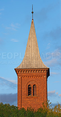 Buy stock photo Architecture roof design of church steeple and spire on gothic style cathedral building against blue sky. Tall infrastructure and tower used to symbolise faith and Christian or Catholic devotion