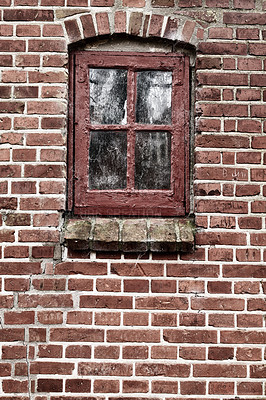 Buy stock photo Old dirty window in a red brick house or home. Ancient casement with red wood frame on a historic building with clumpy paint texture. Exterior details of a windowsill in a traditional town or village