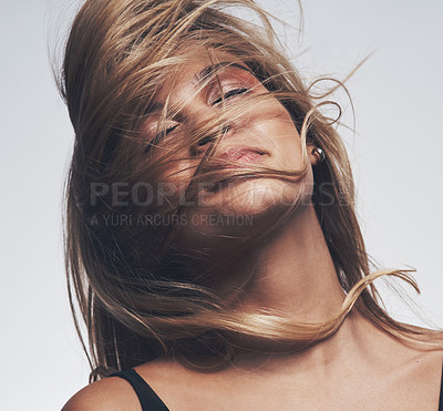 Buy stock photo Shot of a woman's hair covering her face while posing against a grey background