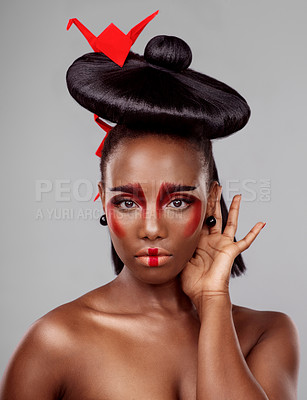 Buy stock photo Creative beauty, face and black woman with origami in studio isolated on dark background. Portrait, makeup and skincare with African female person, traditional and Japanese paper for art deco 