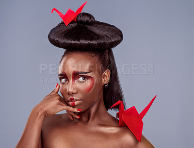 Buy stock photo Beauty, makeup and origami with black woman in studio for creative, cosmetics and asian aesthetic. Traditional, paper design and model for heritage, art and confidence on gray background