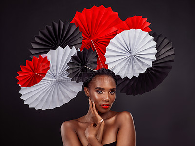 Buy stock photo Beauty, portrait and black woman with origami fans in studio isolated on a dark background. Serious face, makeup cosmetics and skincare of female model with traditional Japanese paper art for culture