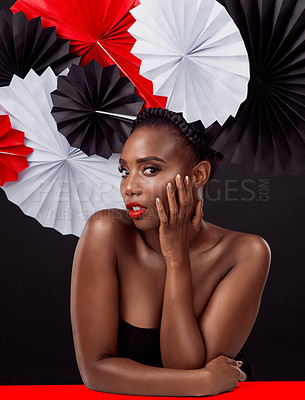 Buy stock photo Woman, portrait and beauty with origami fans in studio isolated on a dark background. Face, makeup cosmetics and skincare of black female model with traditional craft paper art for geisha headwear