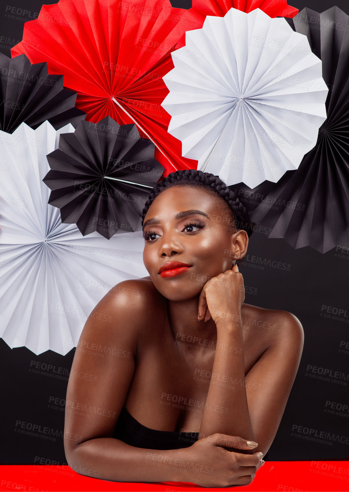 Buy stock photo Creative, thinking and black woman with origami fans in studio, beauty and dark background. Face, makeup and cosmetics of female model with pride, traditional, smile and and paper art for culture hat