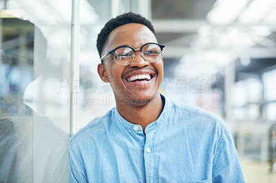 Buy stock photo Portrait of a confident young businessman working in a modern office