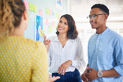Buy stock photo Shot of a group of young businesspeople having a brainstorming session in a modern office
