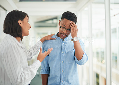 Buy stock photo Shot of a young businesswoman comforting her colleague in a modern office