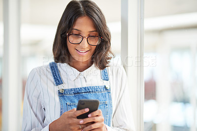 Buy stock photo Happy woman, reading and typing with phone for communication, text or online news at office. Young female person or employee with smile for mobile smartphone, chatting app or connection at workplace