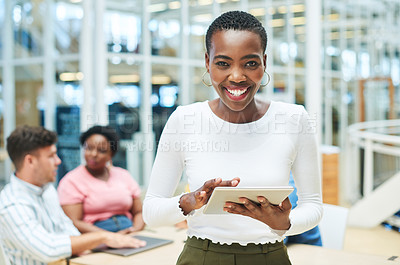 Buy stock photo Shot of a young businesswoman using a digital tablet during a team meeting in a modern office
