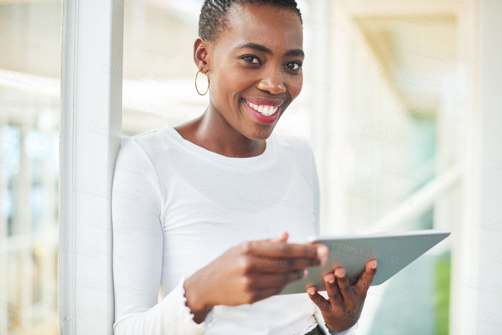 Buy stock photo Shot of a young businesswoman using a digital tablet in a modern office