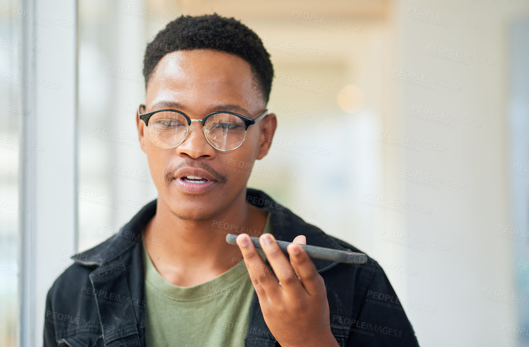 Buy stock photo Black man, business and talking on speaker with phone for audio message, recording or communication at office. Young African or employee on mobile smartphone for voice note or sound mail at workplace