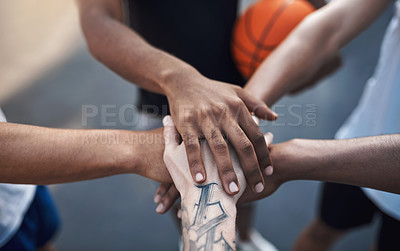Buy stock photo Closeup shot of a group of sporty young men joining their hands together in a huddle on a sports court
