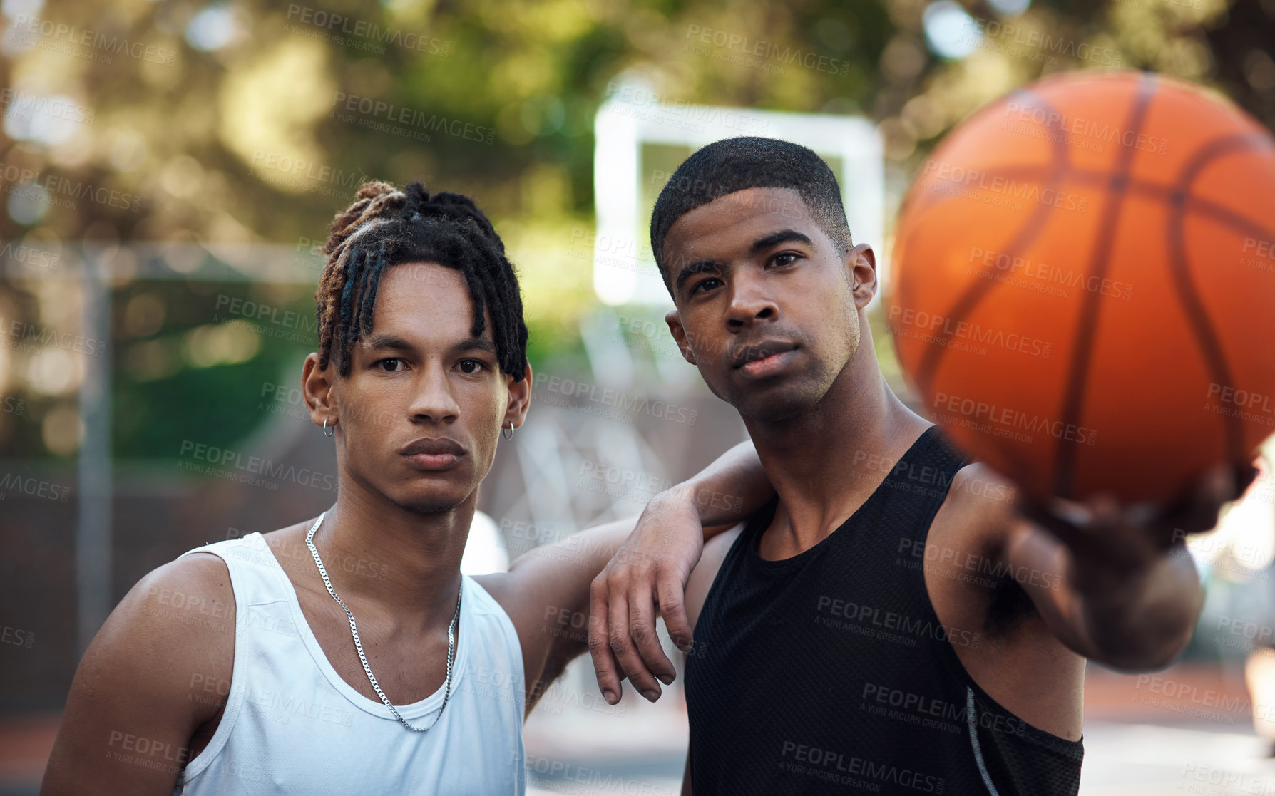Buy stock photo Portrait of two sporty young men standing on a basketball court