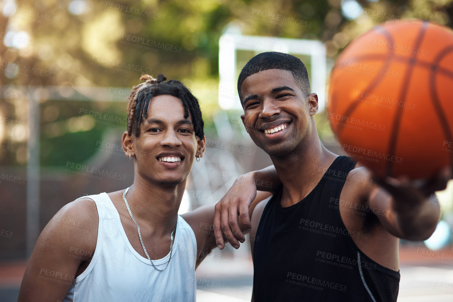 Buy stock photo Portrait of two sporty young men standing on a basketball court