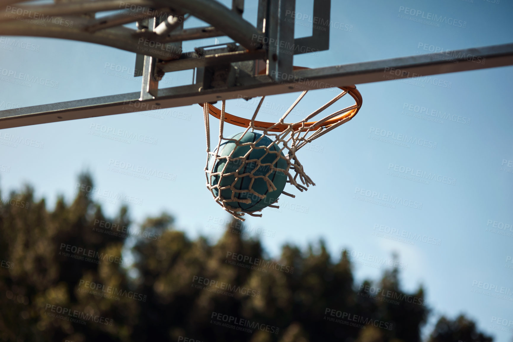 Buy stock photo Closeup shot of a basketball landing into a net on a sports court